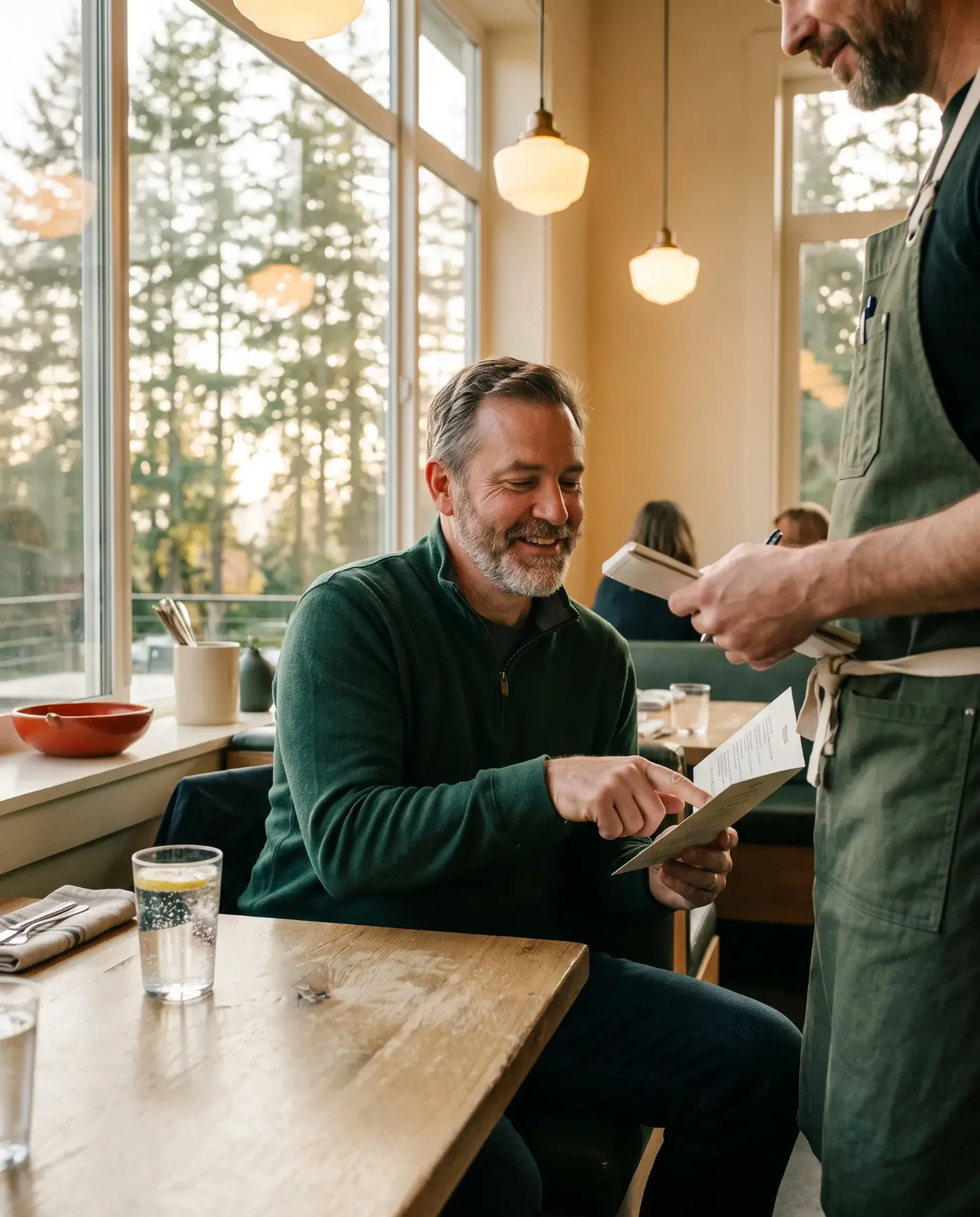 A guest ordering from a server at a neighborhood restaurant